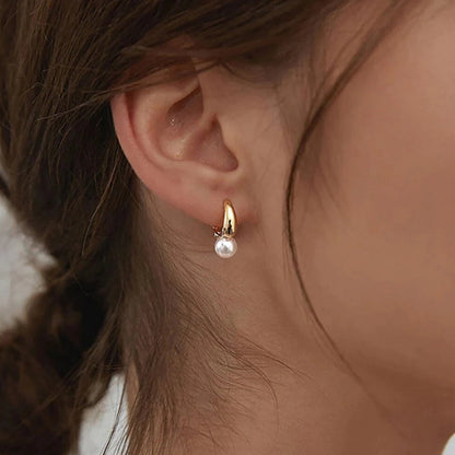Small golden pearl earrings