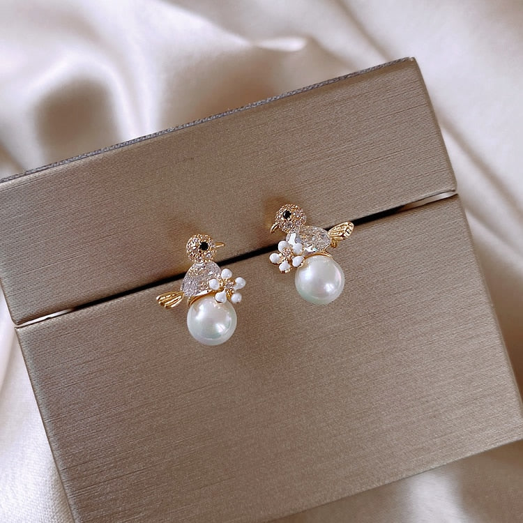Luxury earrings with small zirconia bird and pearl inlay