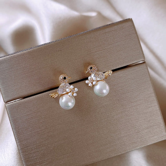 Luxury earrings with small zirconia bird and pearl inlay