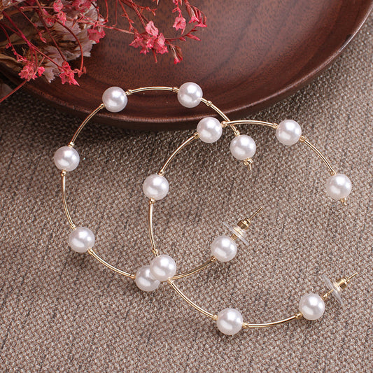Hoop earrings with a succession of pink-plated pearls and zircons
